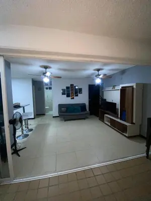 a large living room with a couch and a table at Apartasol Santafe de Antioquia in Santa Fe de Antioquia