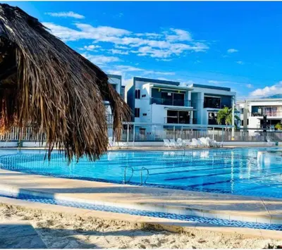 a resort swimming pool with a building in the background at Apartasol Santafe de Antioquia in Santa Fe de Antioquia