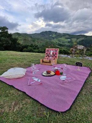 a purple picnic table with a plate of food on it at Valle Sereno, Hospedaje rural cerca del Salto del Buey in Abejorral