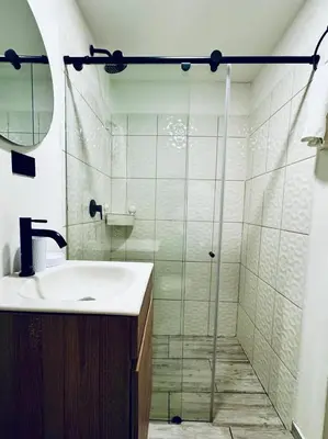 a bathroom with a sink and a shower at Apartaestudio Medellin - Santa Lucia in Medellín