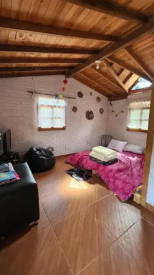 a bedroom with a pink bed in a room at Finca Acogedora con Área de BBQ, Parking Privado y Hamacas in Guarne