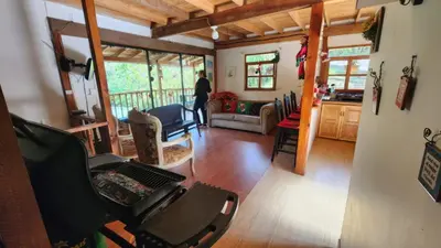 a person is standing in a living room at Finca Acogedora con Área de BBQ, Parking Privado y Hamacas in Guarne