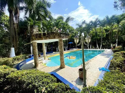 a swimming pool with a bridge in a resort at Finca Balvanera in Sopetran