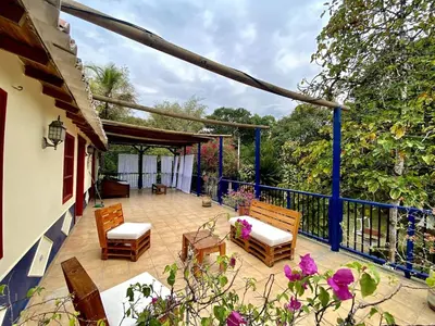 a patio with chairs and a fence and flowers at Finca Balvanera in Sopetran