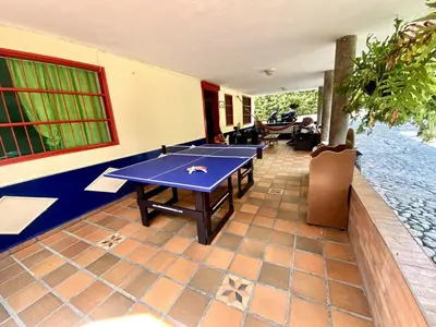 a room with a ping pong table in it at Finca Balvanera in Sopetran