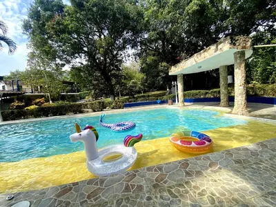 a pool with a unicorn float and toys in it at Finca Balvanera in Sopetran