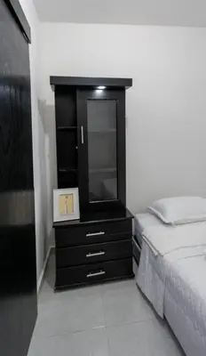 a bedroom with a black dresser and a bed at Apartamento a 15 minutos Aeropuerto y Rionegro in Rionegro