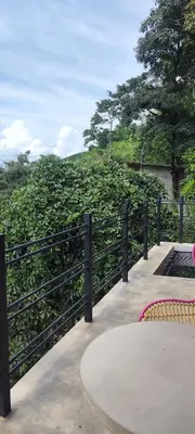 a table and chairs next to a fence at Glamping Raíces in Manizales