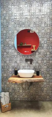 a bathroom with a sink and a mirror on a wall at Glamping Raíces in Manizales