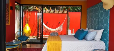 a bedroom with a bed and a red wall at Glamping Raíces in Manizales