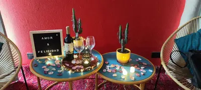 two tables with wine glasses and candles on them at Glamping Raíces in Manizales