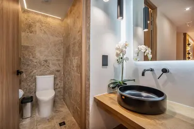 a bathroom with a sink and a toilet at LIN Boutique Hotel by HOUSY in Medellín