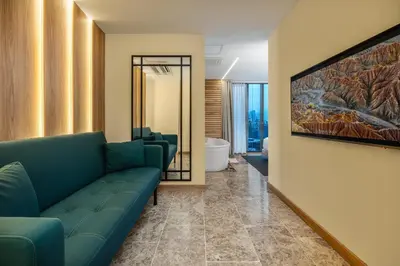 a living room with a couch and a painting on the wall at LIN Boutique Hotel by HOUSY in Medellín
