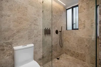 a bathroom with a shower and a toilet at LIN Boutique Hotel by HOUSY in Medellín
