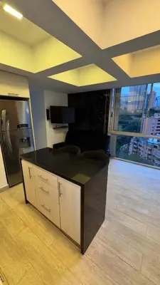 a living room with a couch and a large window at 2103 Apto de lujo Poblado Medellín in Medellín
