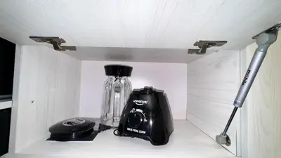 a glass bottle and a camera on a shelf at 2103 Apto de lujo Poblado Medellín in Medellín