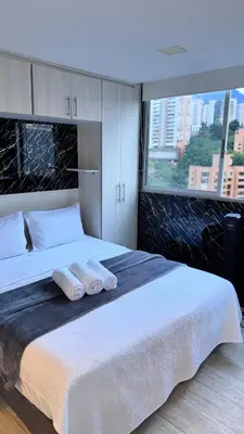 a bedroom with a large bed with towels on it at 2103 Apto de lujo Poblado Medellín in Medellín