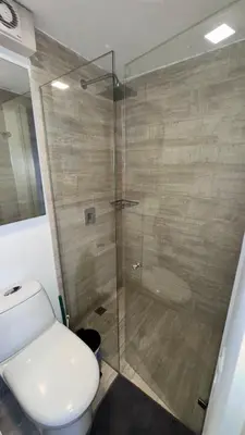 a bathroom with a toilet and a glass shower at 2103 Apto de lujo Poblado Medellín in Medellín
