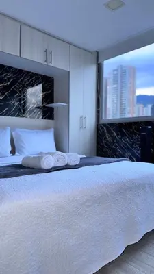 a bedroom with a large bed with towels on it at 2103 Apto de lujo Poblado Medellín in Medellín
