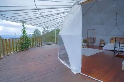 a large white tent on a wooden deck at Cinco Elementos in El Peñol