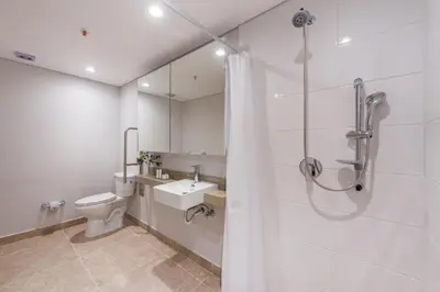a bathroom with a shower and a toilet and a sink at Modern Comfort in El Tesoro Medellín 301 in Medellín