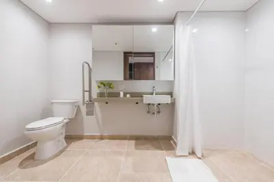 a white bathroom with a toilet and a sink at Modern Comfort in El Tesoro Medellín 301 in Medellín