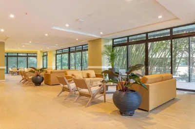 a lobby with couches and chairs and a plant at Modern Comfort in El Tesoro Medellín 301 in Medellín