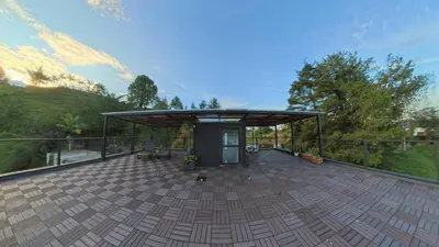 a pavilion on a patio with a roof at Beautiful cabin Guatapé vista-acceso al lago in La Pradera