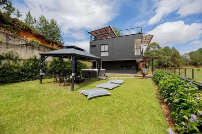 a house with a gazebo in the yard at Beautiful cabin Guatapé vista-acceso al lago in La Pradera