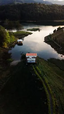 an aerial view of a river with two boats in it at EL NiDO HOTEL GUATAPE in Guatapé