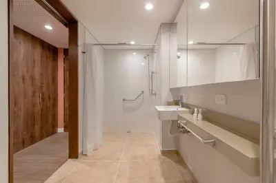 a white bathroom with a sink and a mirror at Elegant Stay Steps from El Tesoro Mall 304 in Medellín