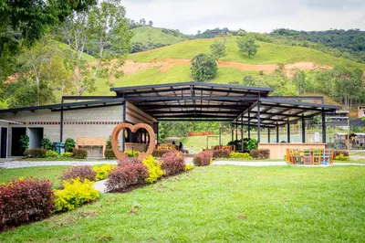 a building with a hill in the background at Camping bajo techo y con estilo in San Rafael