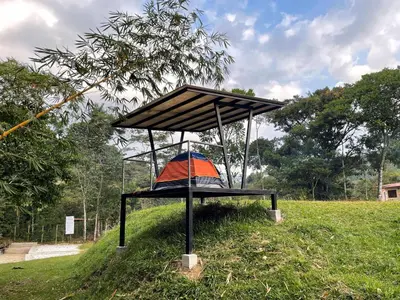 a structure sitting in the grass in a field at Camping bajo techo y con estilo in San Rafael