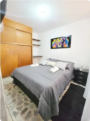 a bedroom with a bed with two towels on it at exclusive apartment in laureles Estadio in Medellín