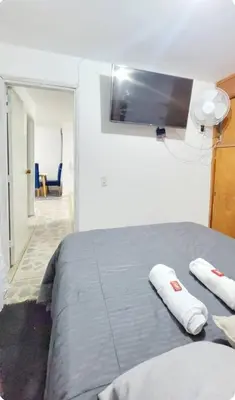 a bedroom with a bed with two pillows on it at exclusive apartment in laureles Estadio in Medellín