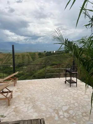 a patio with a bench and a view of a field at Cabaña en Santa Fe de Antioquia in Santa Fe de Antioquia