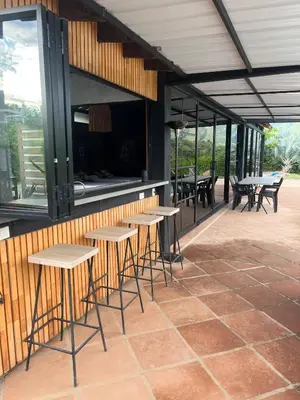 a row of tables and chairs on a patio at Cabaña en Santa Fe de Antioquia in Santa Fe de Antioquia