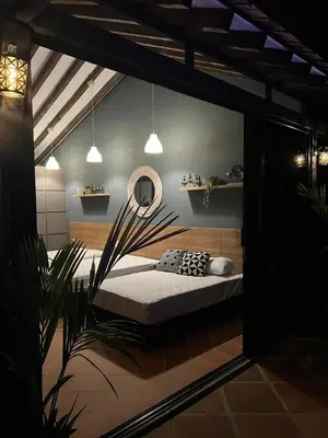 a bedroom with a bed and a mirror and a plant at Cabaña en Santa Fe de Antioquia in Santa Fe de Antioquia