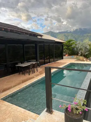a house with a swimming pool and a table at Cabaña en Santa Fe de Antioquia in Santa Fe de Antioquia