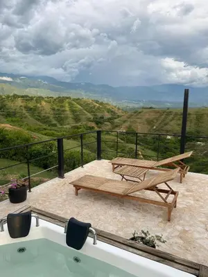 a bath tub sitting on a patio with a bench at Cabaña en Santa Fe de Antioquia in Santa Fe de Antioquia