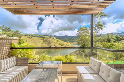 a living room with a view of a river at Villa reservoir view in Guatapé