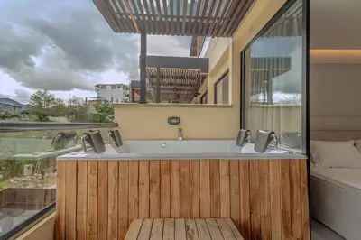 a bathroom with a bath tub with a window at Villa reservoir view in Guatapé