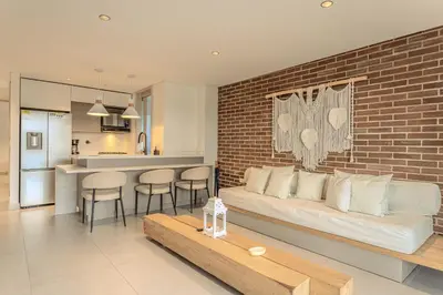 a living room with a couch and a brick wall at Villa reservoir view in Guatapé