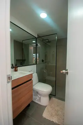 a bathroom with a toilet and a sink and a shower at Céntrico Apartaestudio en el Parque de Poblado in Medellín