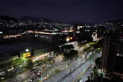 a city street at night with cars on the road at Deluxe apartment with an incredible view in envigado in Envigado
