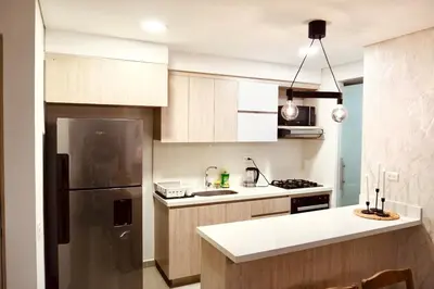 a kitchen with a refrigerator and a counter top at Deluxe apartment with an incredible view in envigado in Envigado