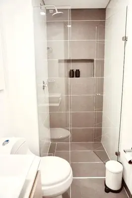 a bathroom with a shower with a toilet and a sink at Deluxe apartment with an incredible view in envigado in Envigado