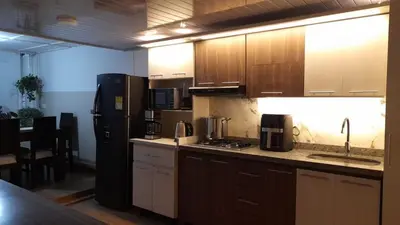 a kitchen with a refrigerator and a counter top at Modern, Comfortable, Spacious & Central in Manizales