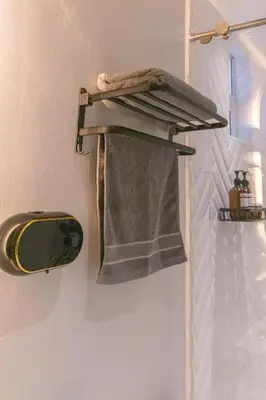 a towel hanging on a wall next to a mirror at Luxury penthouse with Jacuzzi and AC, North Medellin in Medellín