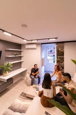 a group of people sitting in a living room at Luxury penthouse with Jacuzzi and AC, North Medellin in Medellín